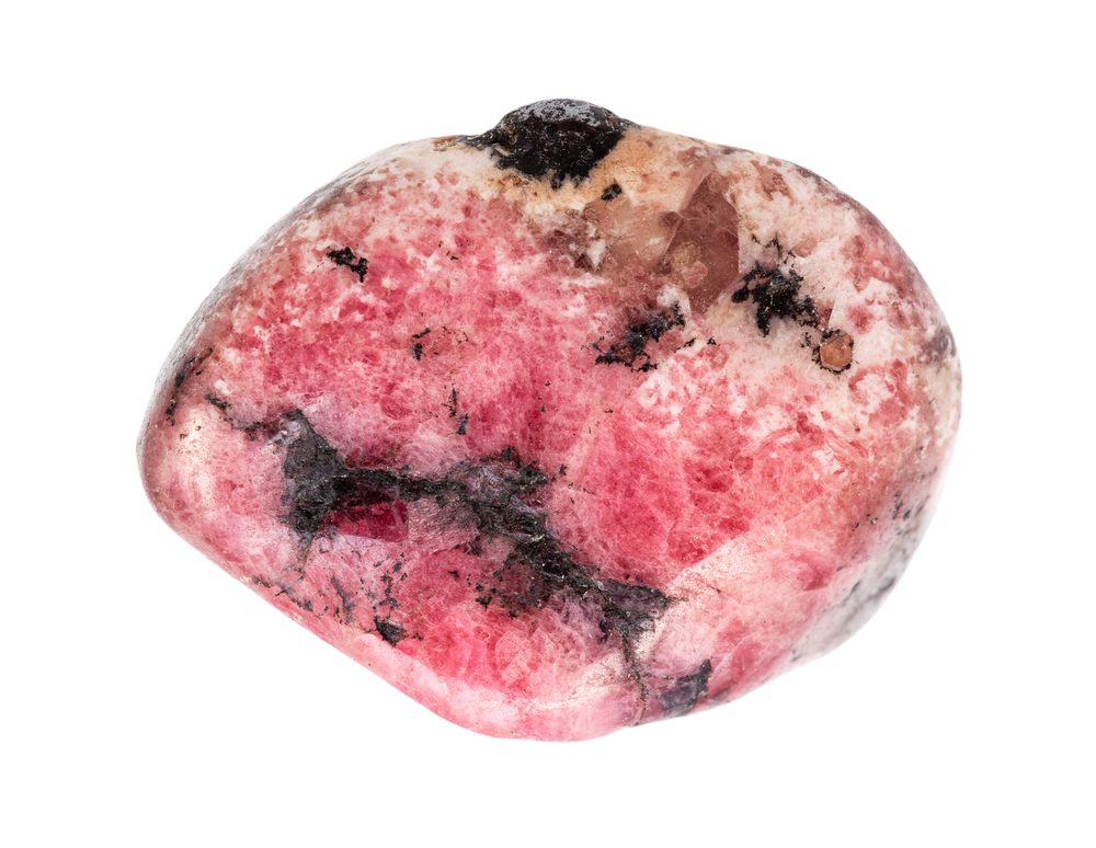 closeup of sample of natural mineral from geological collection - tumbled Rhodonite gem isolated on white background