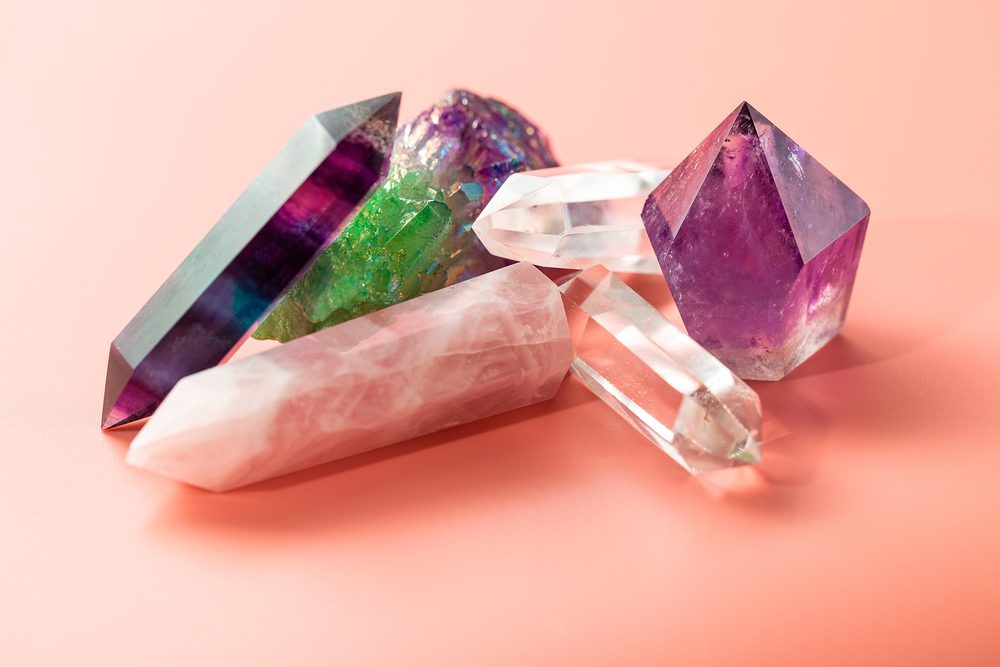 best crystals for anxiety, healing and magical practices. Faceted amethyst, rose quartz, fluorite, rock crystal, quartz cluster on pastel background