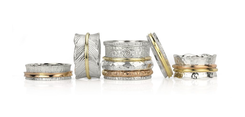 Assortment of spinning rings in silver, gold, and gemstone designs