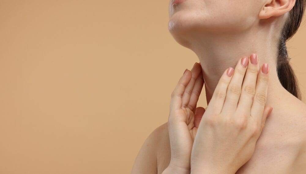 Woman practicing vagus nerve stimulation techniques at home, including deep breathing, cold exposure, and vagus nerve massage for anxiety relief