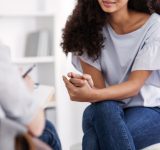 Beautiful african american girl during meeting with professional counselor; finding the right therapist