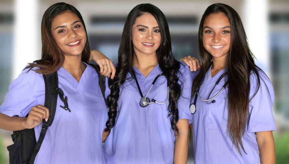 Three happy hispanic nursing students at school
