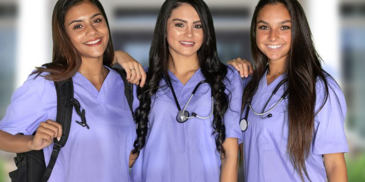 Three happy hispanic nursing students at school