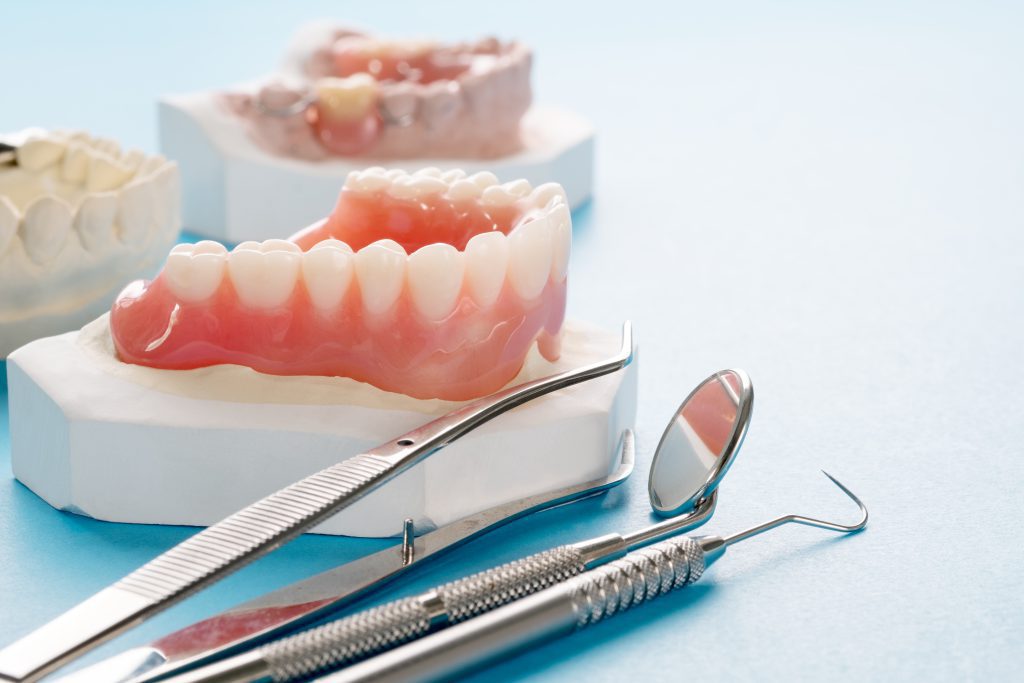 Ease denture fears with Close up , Complete denture or full denture on blue background.