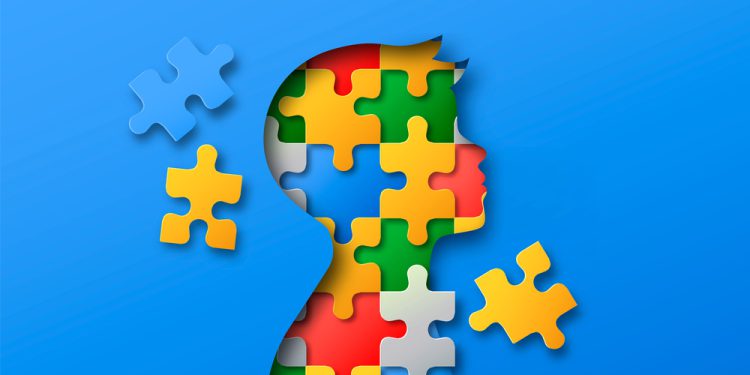 Little boy head profile silhouette made of colorful paper cut puzzle pieces. Children education or psychology illustration concept in realistic 3d papercut style to represent Applied Behavior Analysis Therapy