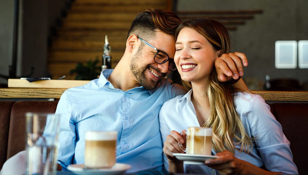Romantic loving young couple dating as a single parent, drinking coffee, having a date in the cafe.