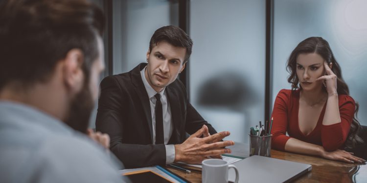 Difficult situation. A calm and confident layer resolving a dispute between spouses