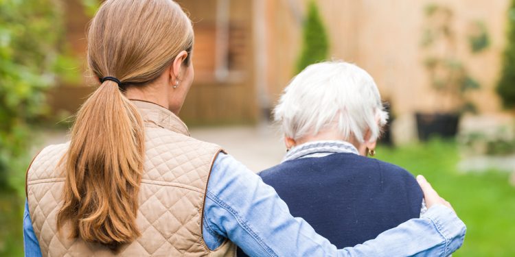 Caregiver holding a calming tool like a fidget ring, highlighting tips for effective home care support and stress relief