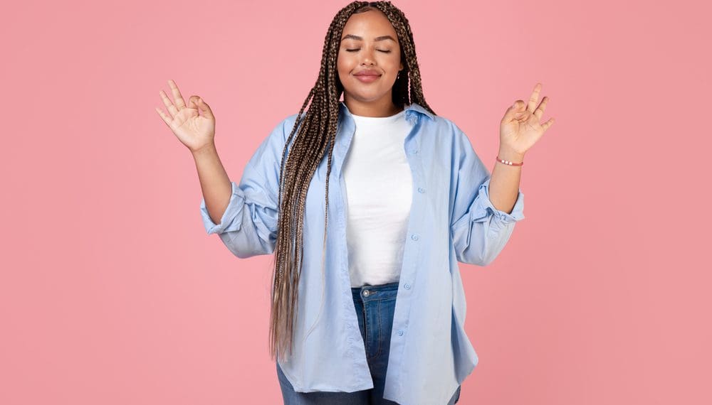 Woman practicing deep breathing exercises with a fidget ring, using mindfulness techniques to calm an anxiety attack.