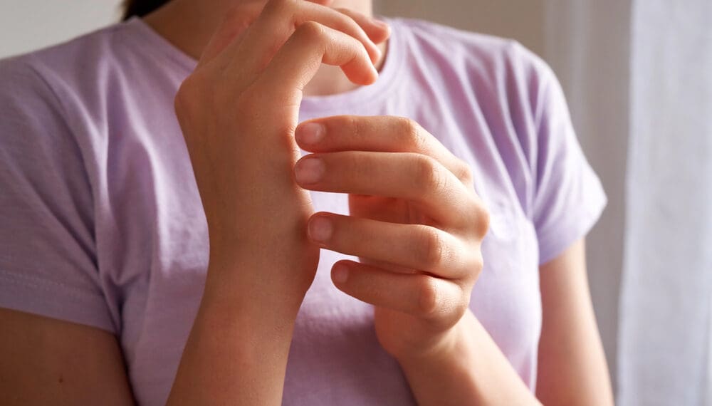 Woman practicing EFT tapping for anxiety, stress relief, emotional healing, trauma release, mental health support, and mind-body connection at home.
