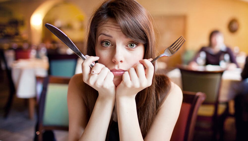 Anxious woman skipping a meal due to anxiety-related loss of appetite